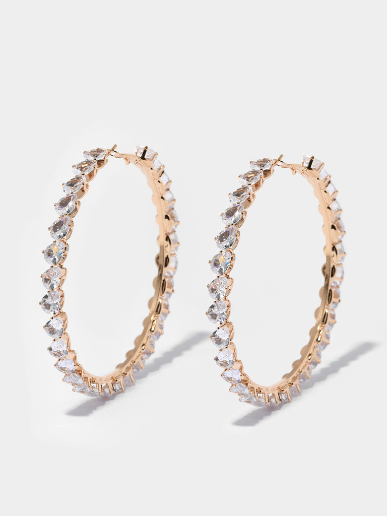 gold hoops lined with pear shaped, clear-colored crystal gems