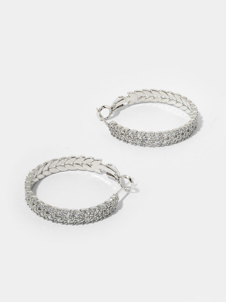 Product image of silver hoops with leaf shaped motif covered in small crystals