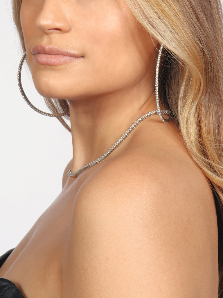 woman wearing silver hoops lined with small clear crystal gems