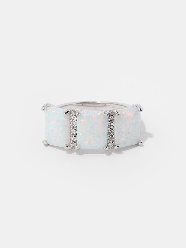 silver ring with 3 square shaped opal gems and two columns of clear-colored crystals in between them