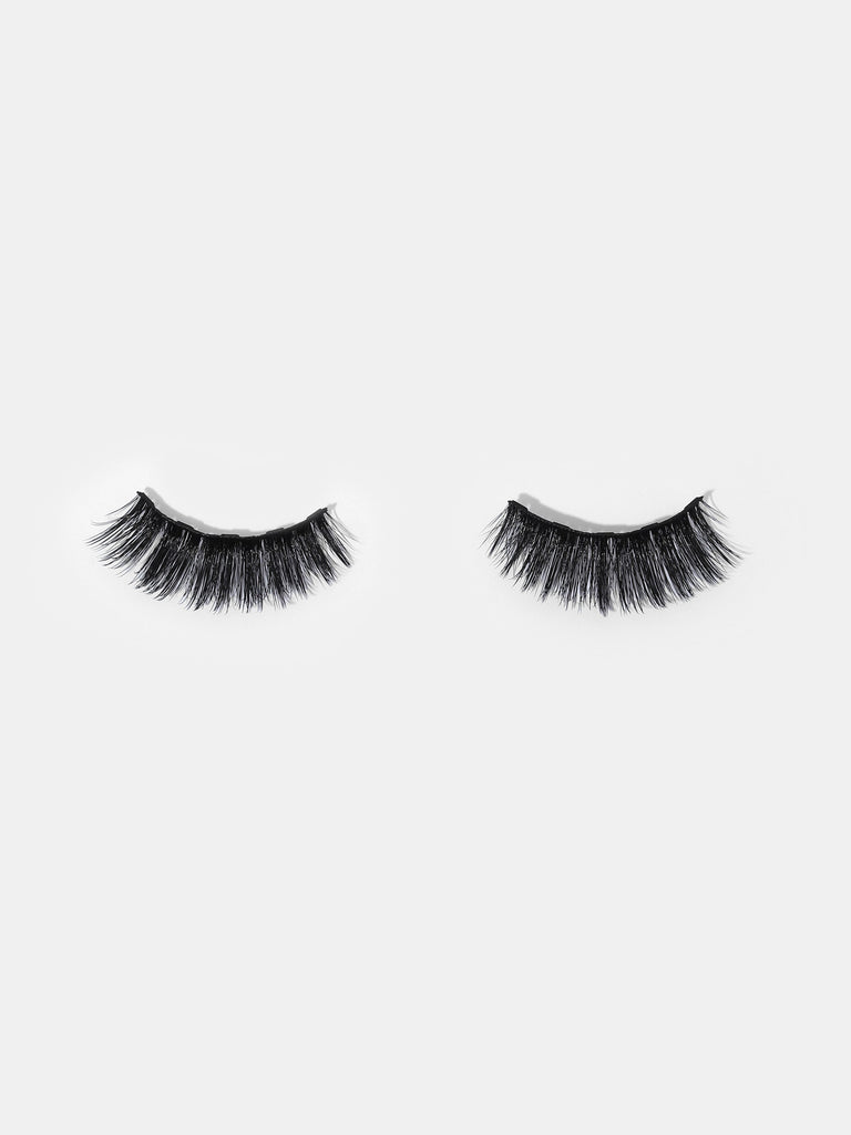 A pair of eyelashes resting on a white background