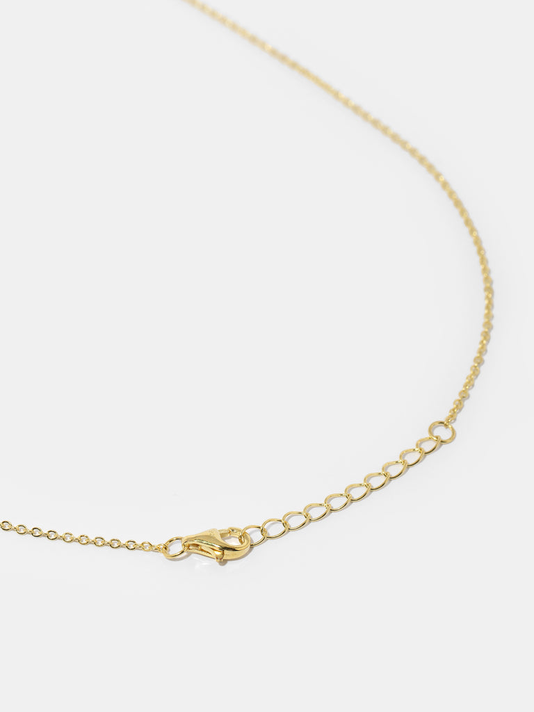 gold necklace with cross pendant covered in small, round, clear-colored crystals