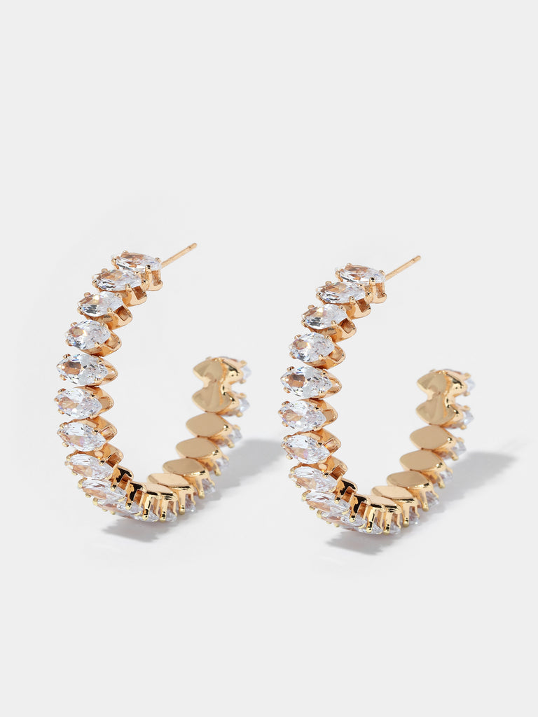 Product shot of a pair of gold marquise cut crystal hoops