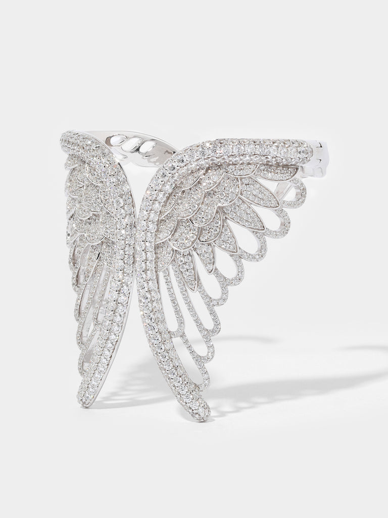 Product image of a silver angel wing shaped cuff bracelet covered in small crystal gems