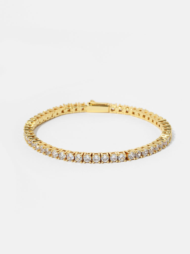 gold bracelet with clear-colored crystal gems all around