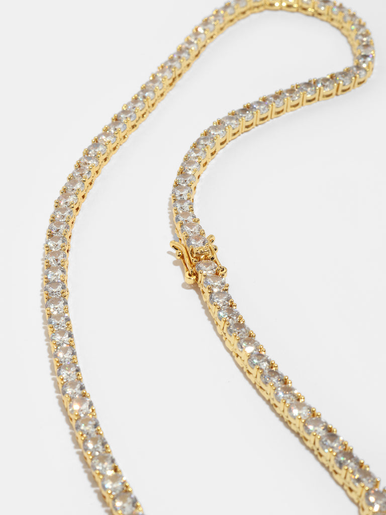 clasp of gold necklaces with round clear-colored, crystals all around