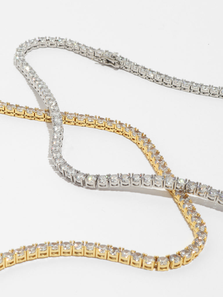 silver and gold necklaces with round clear-colored, crystals all around