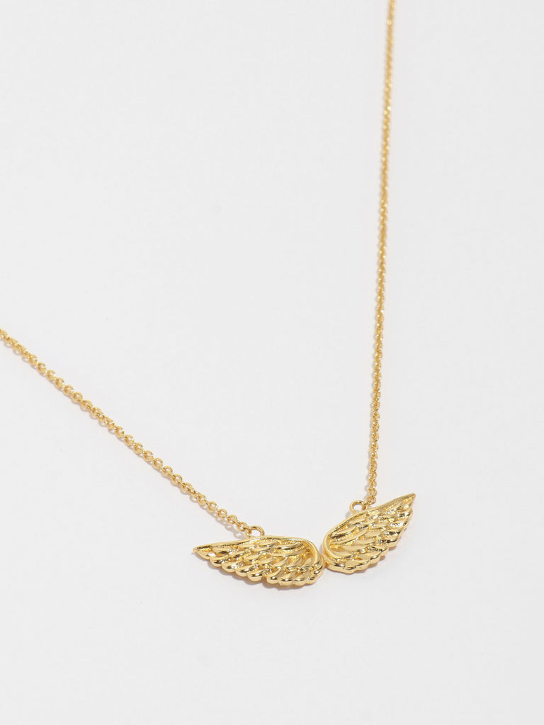 gold necklace with angel wing motif pendant