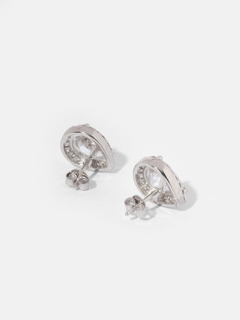 image of the back of silver stud earrings with large, clear-colored, pear shaped gem outlined by small round crystals
