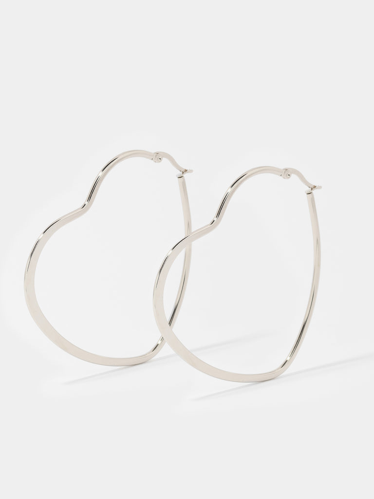 thin heart-shaped, silver hoop earrings 