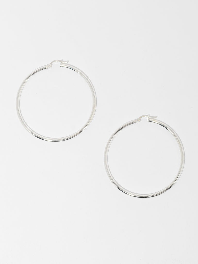 thin silver hoops with round surface
