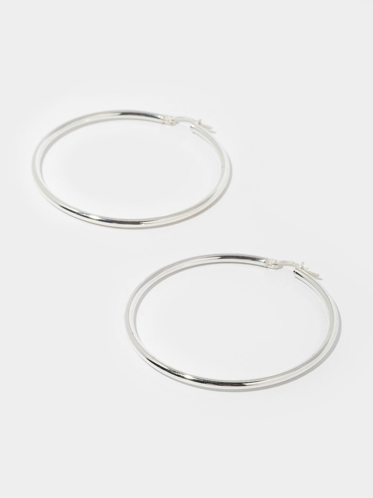 thin silver hoops with round surface