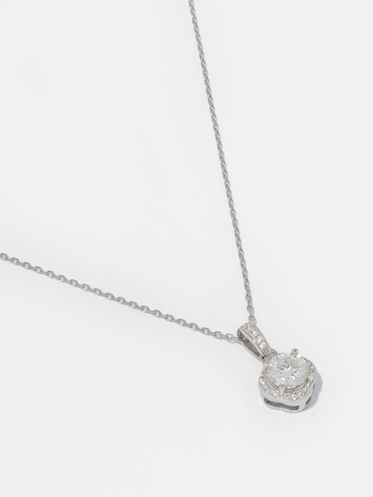 image of silver necklace with clear-colored, large, square shaped gem pendant outlined with small clear-colored crystals