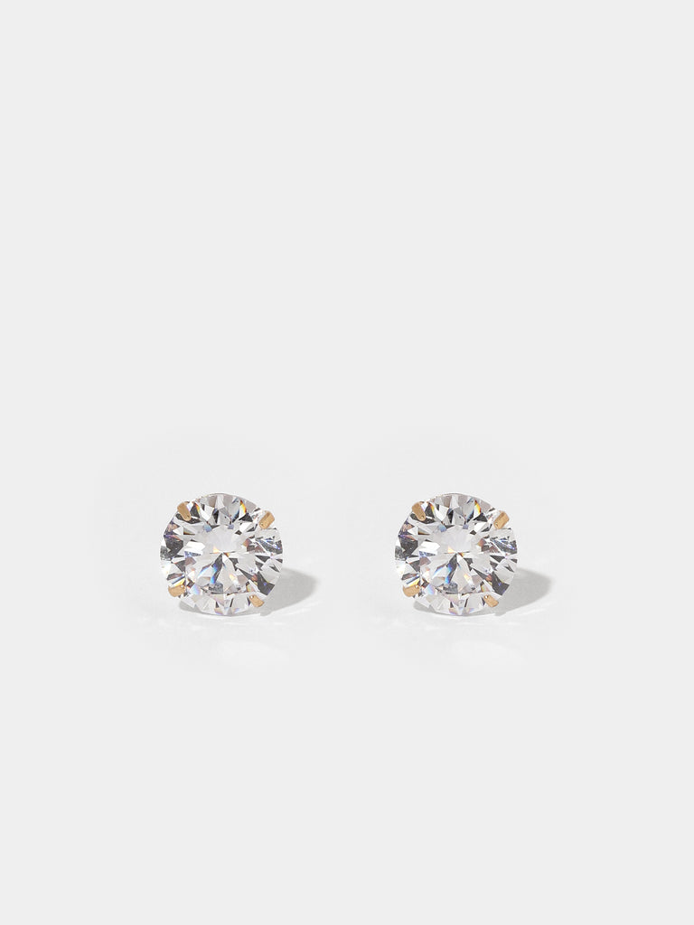gold stud earrings with large, round, clear-colored gems
