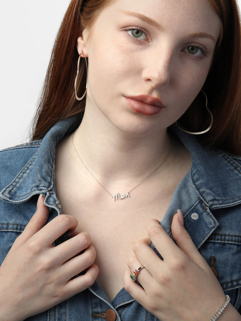 woman wearing thin heart-shaped, silver hoop earrings