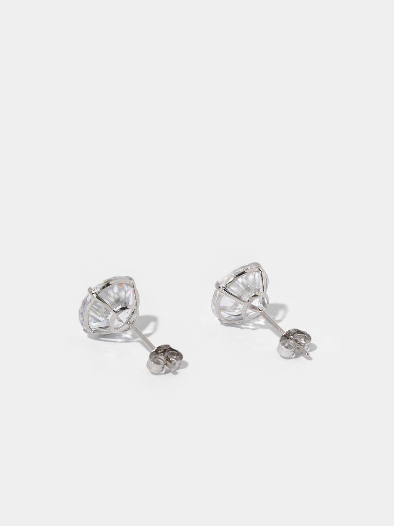 back of silver stud earrings with large, circle, clear-colored gem
