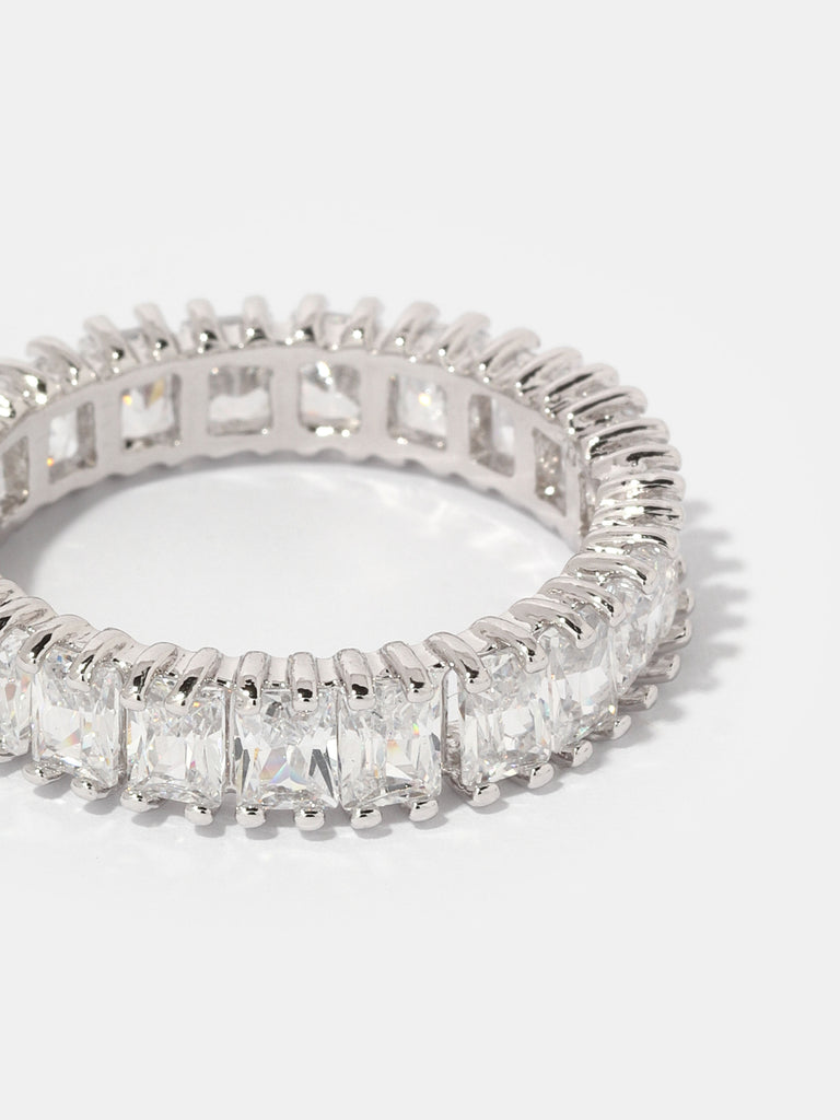 silver ring with rectangular, clear-colored gems all around the band