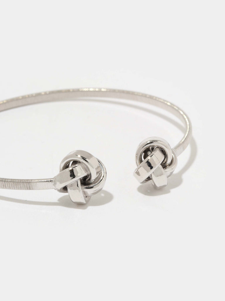 silver bangle bracelet with knotted ball motif in the ends