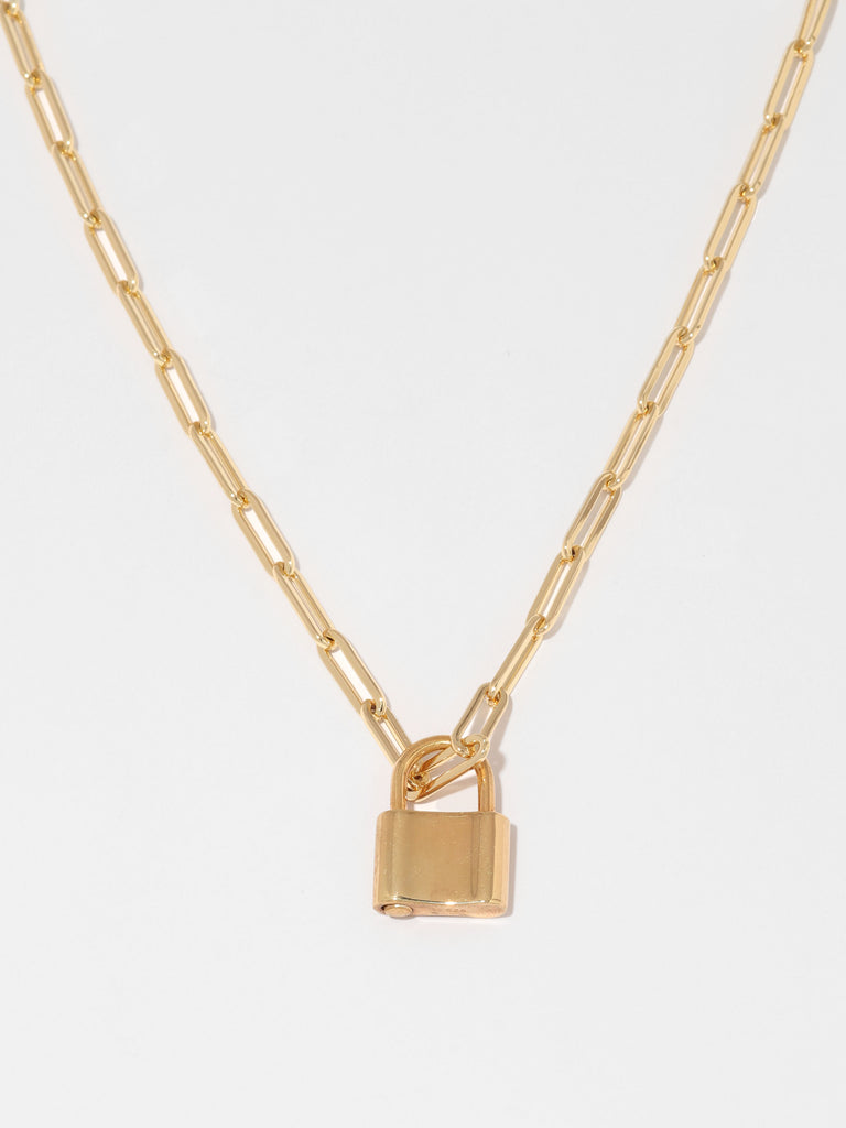 gold necklace with link shaped chain and padlock shaped pendant 
