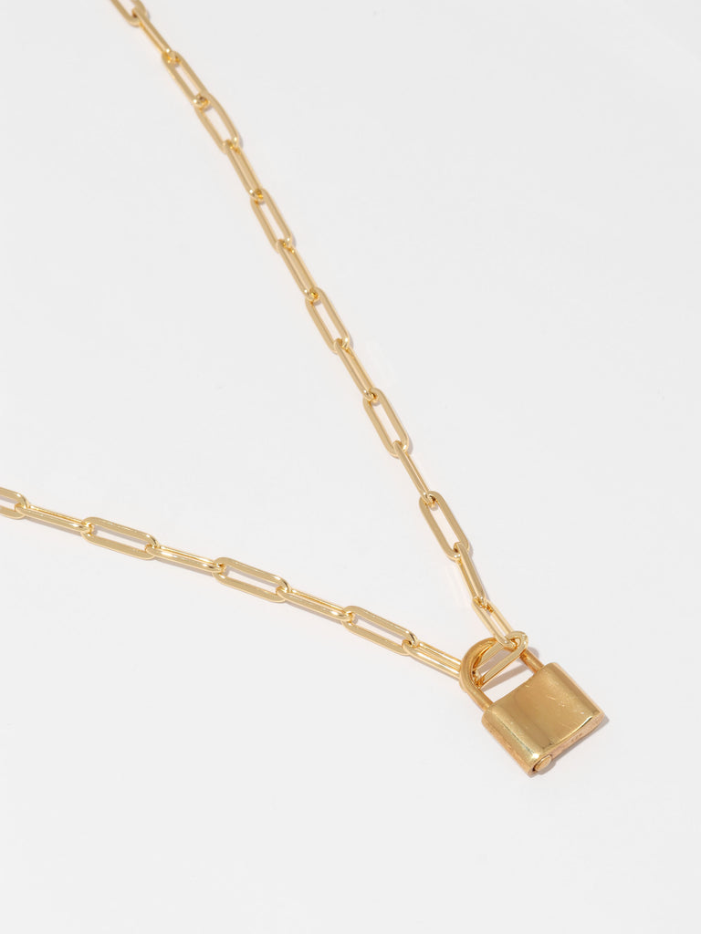 gold necklace with link shaped chain and padlock shaped pendant 