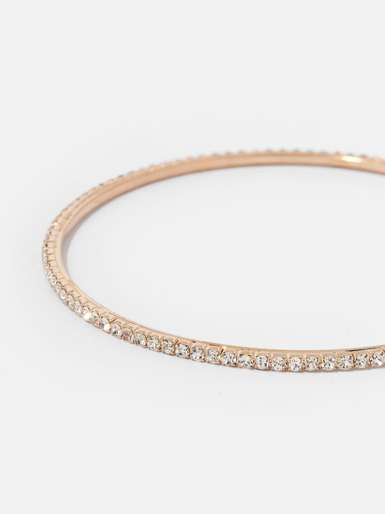 gold hoop lined with small clear crystal gems