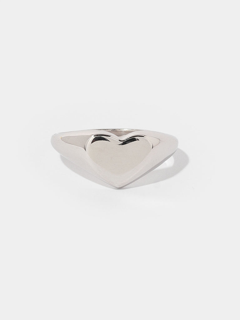 thick silver ring with flat, heart shape center 