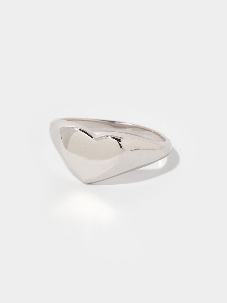 thick silver ring with flat, heart shape center