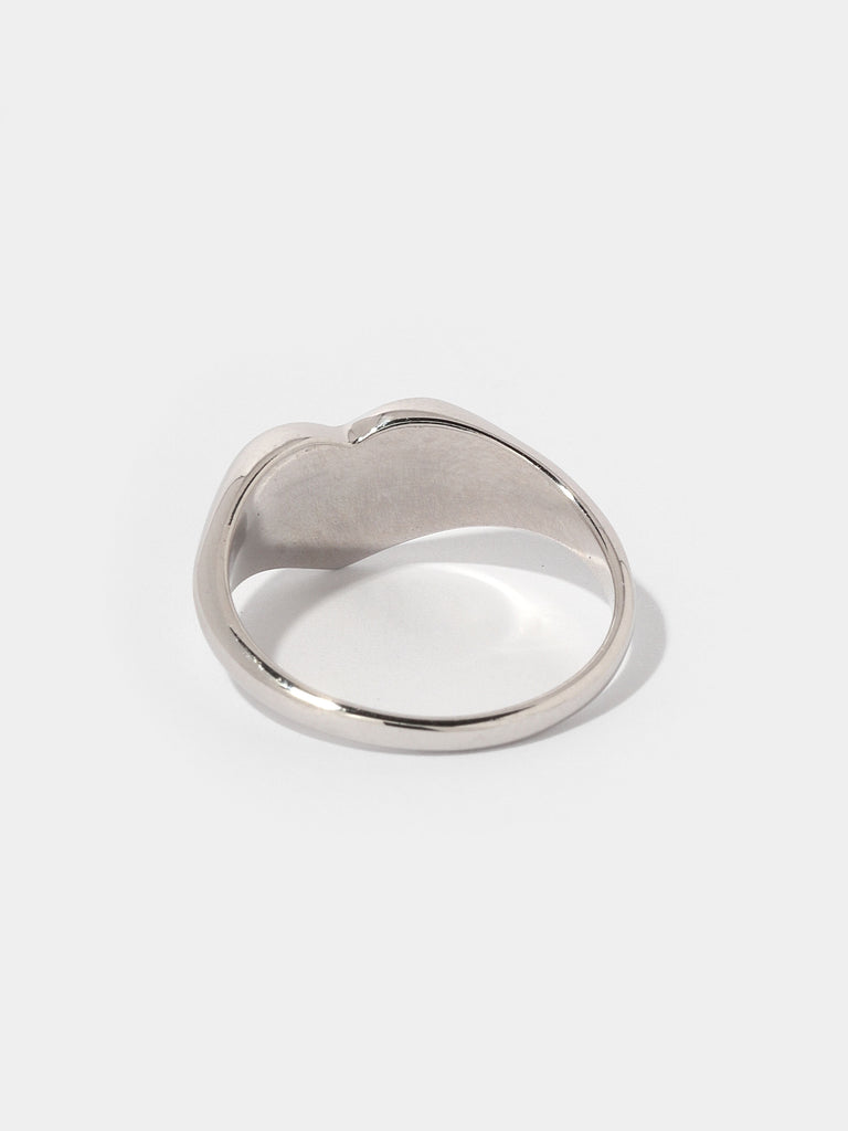 thick silver ring with flat, heart shape center