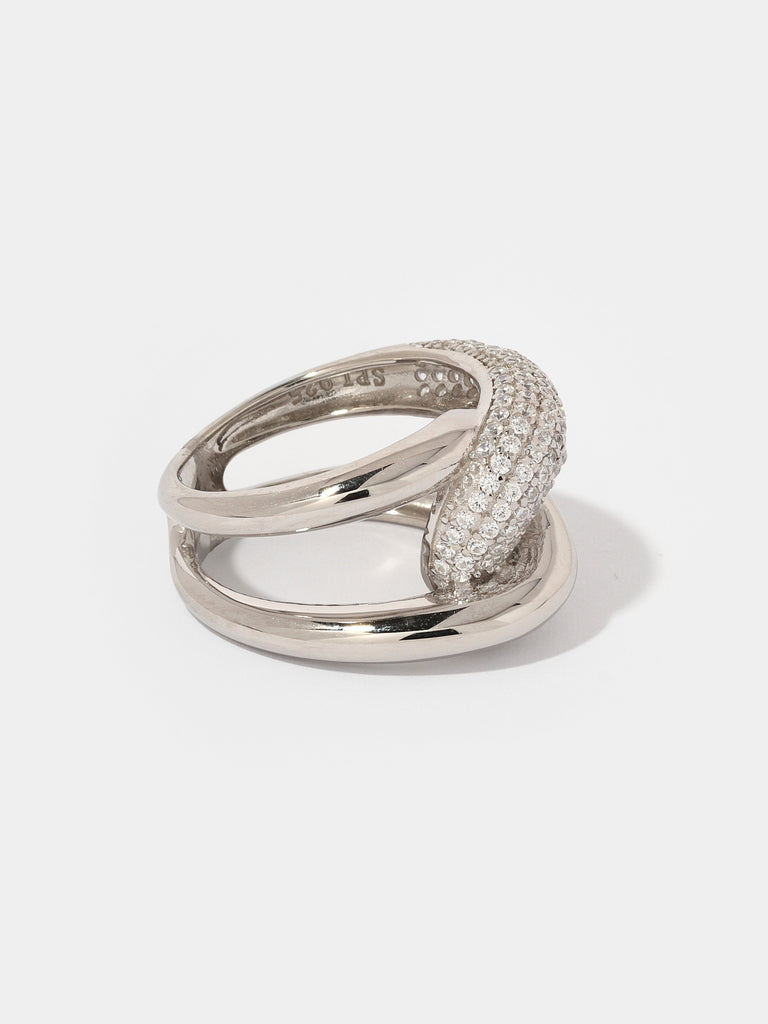 silver ring with knot, infinity shape motif. one side is covered with clear-colored crystals.
