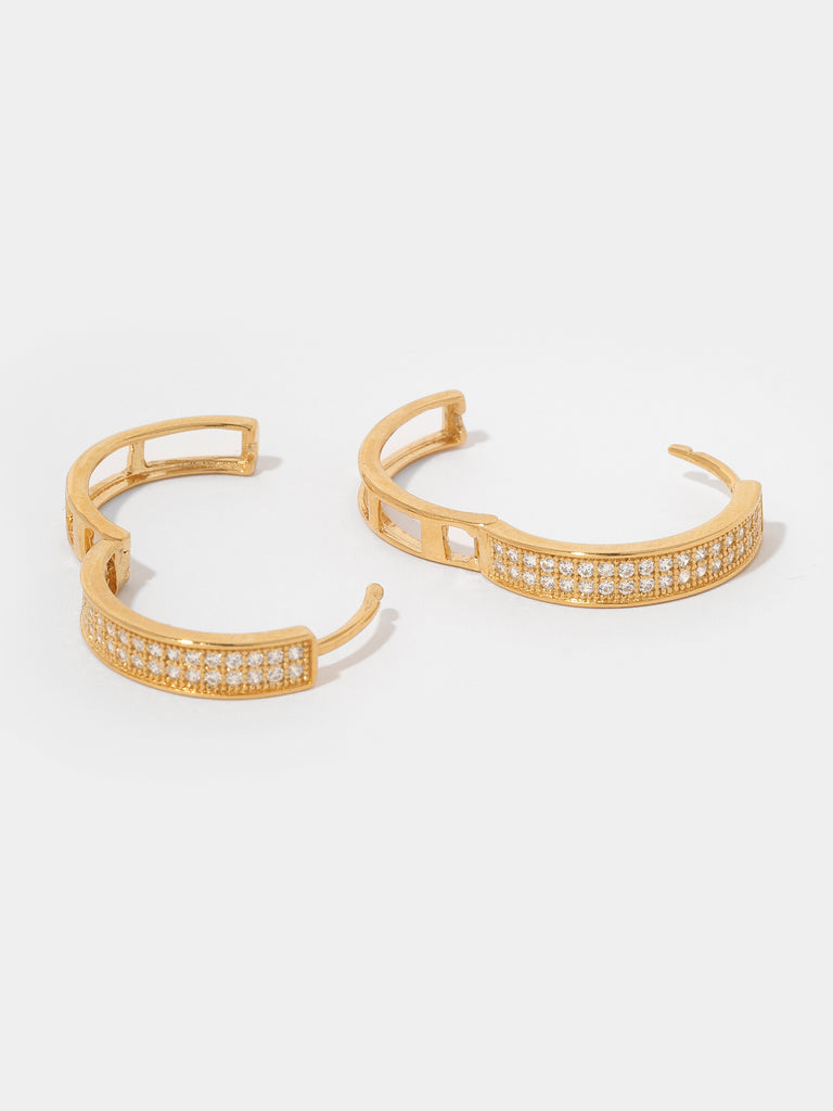 opened gold hoop earrings with the front covered in small round clear-colored crystals and the back is hollow lattice shape