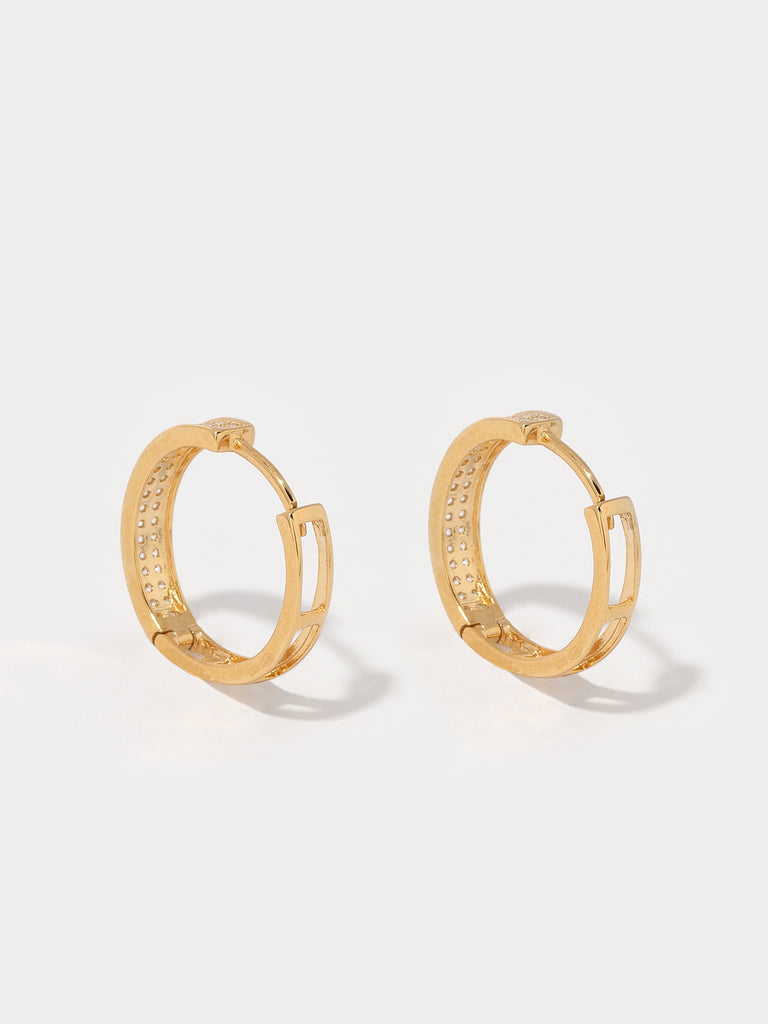 gold hoop earrings with the front covered in small round clear-colored crystals and the back is hollow lattice shape